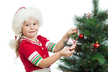 pretty preschool child decorating Christmas tree isolated on whi