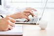© chagin - Business woman typing on laptop keyboard