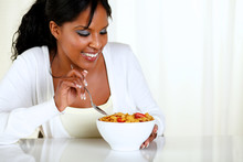 Afro-american Female Eating A Bowl Of Cereals