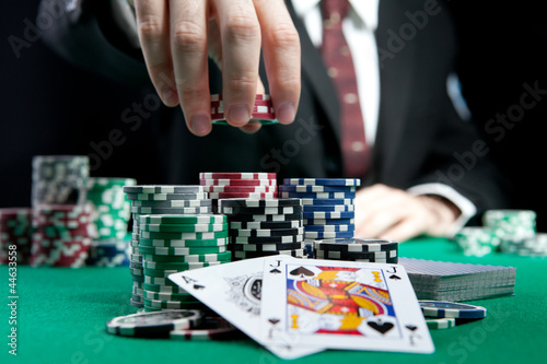Fotografija blackjack in a casino, a man makes a bet, and puts a chip