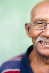 Old black man with glasses and mustache smiling