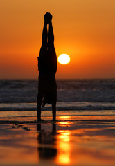 Canvas Print - female gymnast doing a handstand in sunset