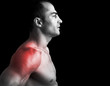 © cristovao31 - Muscular man suffering with shoulder pain on black background