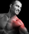 © cristovao31 - Muscular man suffering with shoulder pain on black background