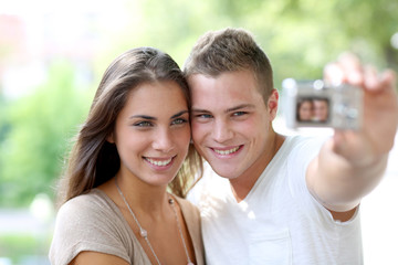 Cute young couple of lovers taking picture of themselves