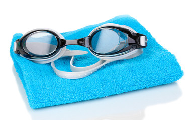 Swim goggles on towel isolated on white