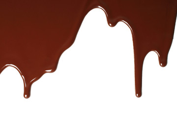 Fototapete - Melted chocolate dripping on white background