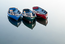 Red, Green And Blue Rowing Boats