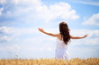 © luckybusiness - Woman in wheat field enjoying
