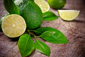 Fresh limes on wooden background