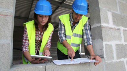 Wall Mural - Construction team working on project with tablet