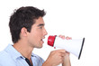 © auremar - Man speaking into a megaphone