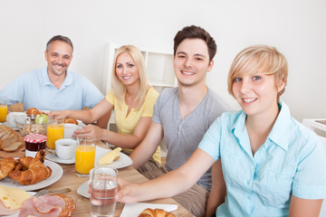 Wall Mural - Happy family enjoying breakfast