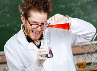 Wall Mural - Crazy scientist mixes two liquids in his laboratory