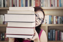 Student Holding Thick Books