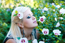 Beautiful Woman In Garden With Flowers