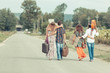 © william87 - Hippie Group Walking on a Countryside Road