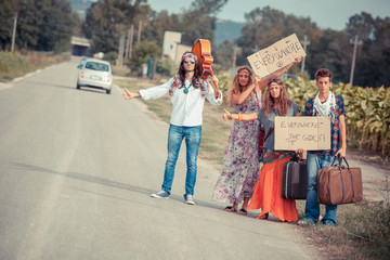 Wall Mural - Hippie Group Hitchhiking on a Countryside Road