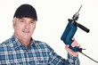 © auremar - Elderly man holding an electric screwdriver