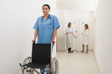 Wall Mural - Nurse pushing empty wheelchair