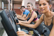 © WavebreakmediaMicro - Four people smiling and riding on an exercise bike