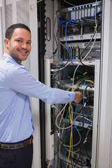 Poster - Smiling man adjusting server