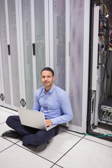 Poster - Technician sitting on the floor and doing maintenance on servers