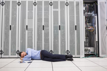 Poster - Man sleeping in front of servers