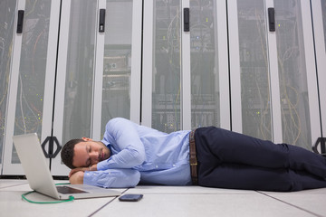 Poster - Man sleeping while doing maintenance on servers