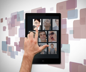 Poster - Hand pointing on tablet pc showing photos