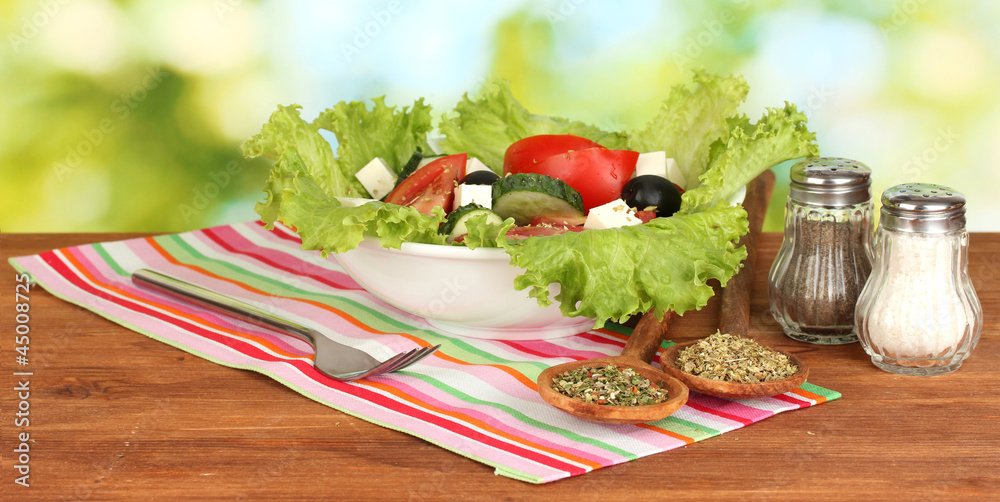 tasty greek salad on bright green background