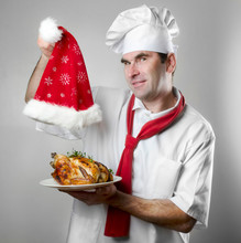 Chef Showing  Plate With Chicken And Santa Hat