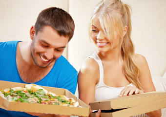 Wall Mural - romantic couple eating pizza at home