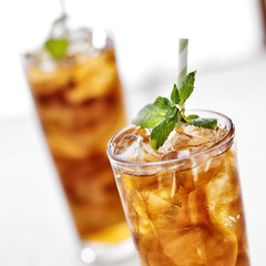 Wall Mural - cold iced tea with mint garnish and sliced lemons