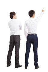 Wall Mural - full length of two businessman pointing and looking