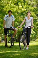 Wall Mural - Happy couple riding bicycle outdoors