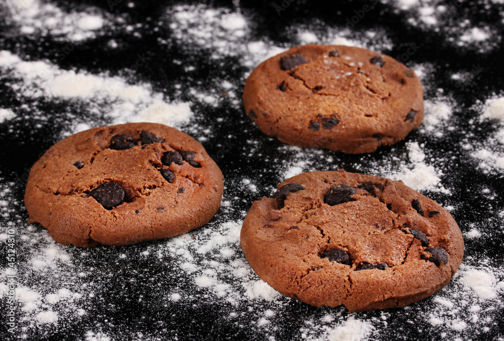 Chocolate chips cookies isolated on black