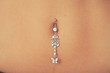 Closeup of a belly button  pierced with jewelry