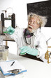Mad scientist conducts chemistry experiment in his lab