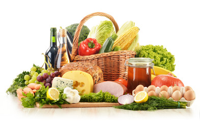 Fototapete - Composition with groceries in wicker basket on kitchen table
