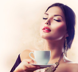 Wall Mural - Coffee. Beautiful Girl Drinking Tea or Coffee