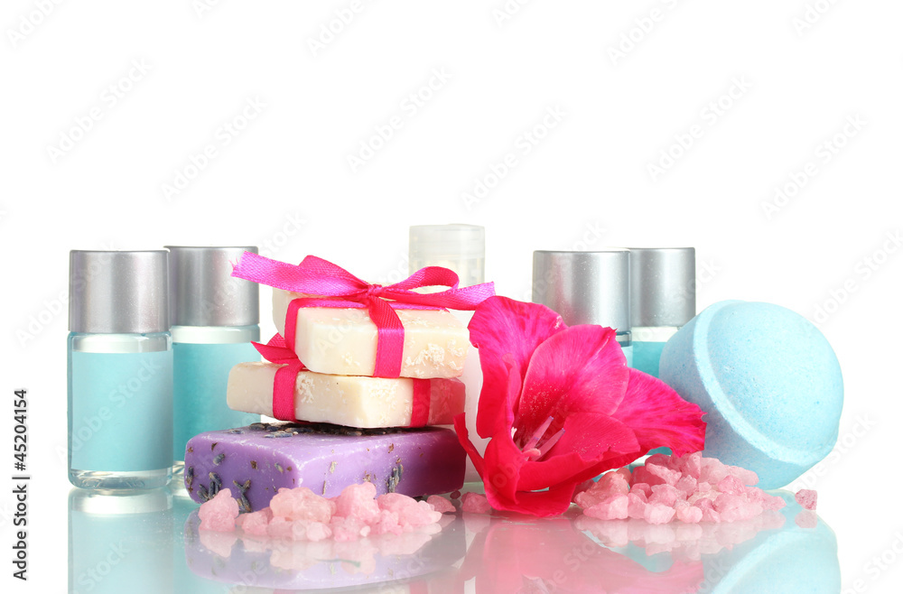 cosmetic bottles, soap and flower, isolated on white.