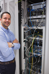 Poster - Smiling man standing in front of servers