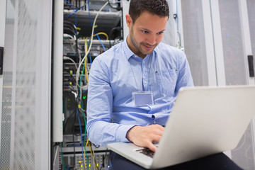 Poster - Man using laptop to check servers