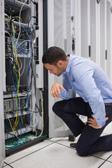 Poster - Technician looking at cables of the server