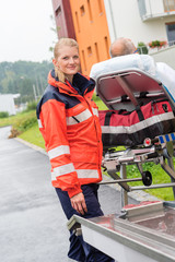 Wall Mural - Patient on stretcher with paramedic emergency aid