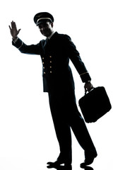 Wall Mural - man in airline pilot uniform silhouette walking