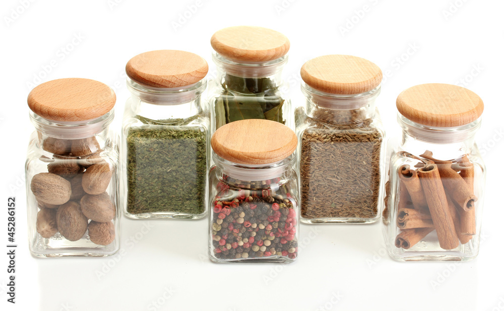 powder spices in glass jars  isolated on white