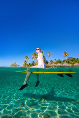 Sticker - Woman sitting on a surfboard at ocean