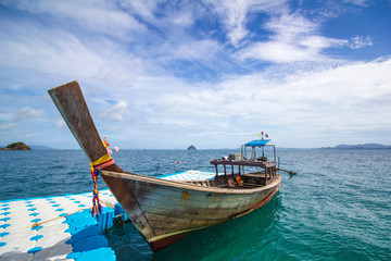 longtail boat and blue dock